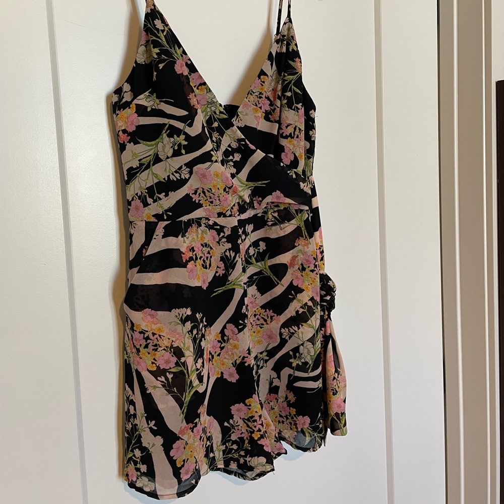 Brand new. Never worn. Guess Romper. Tags attached. Zipper in back.